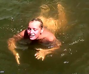 Kathia Nobili swimming naked at the water